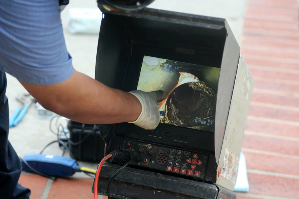 Technician viewing a drain inspection camera in Immokalee