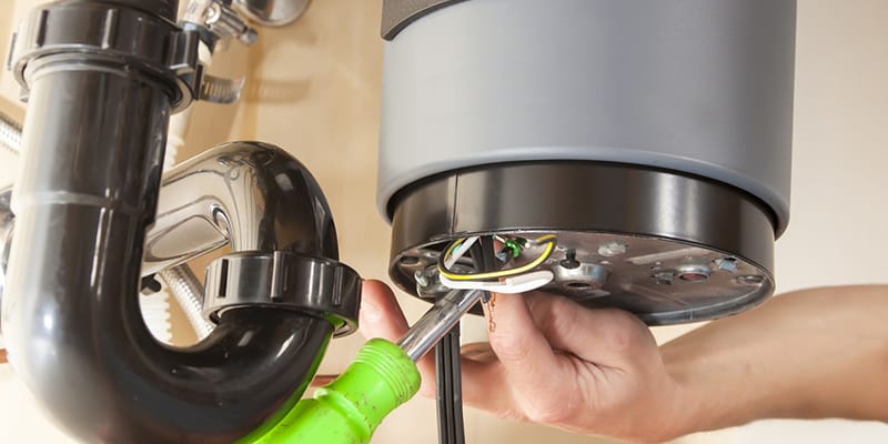 Technician repairing the heating element of a water heater in Immokalee