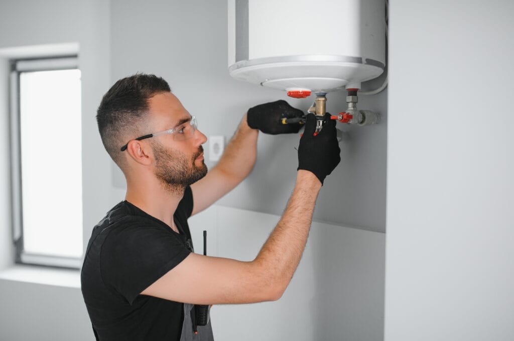 Technician performing water heater maintenance in Immokalee